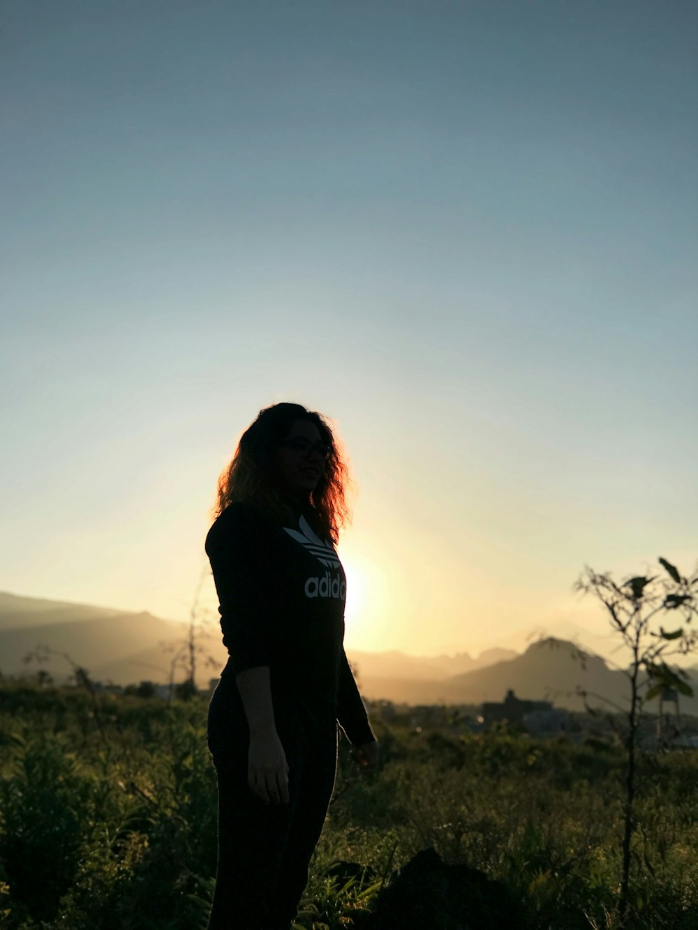 woman in black long sleeve shirt standing on green grass field during daytime