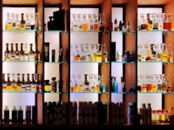 a shelf filled with lots of bottles of liquor