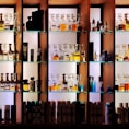 a shelf filled with lots of bottles of liquor