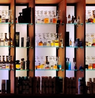 a shelf filled with lots of bottles of liquor