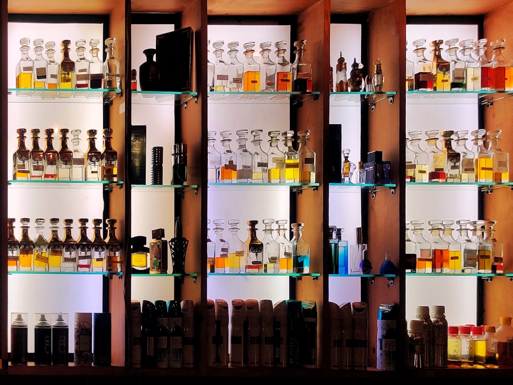 a shelf filled with lots of bottles of liquor
