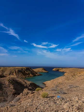 a body of water sitting on top of a rocky hillside