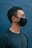 man in black crew neck shirt wearing black sunglasses