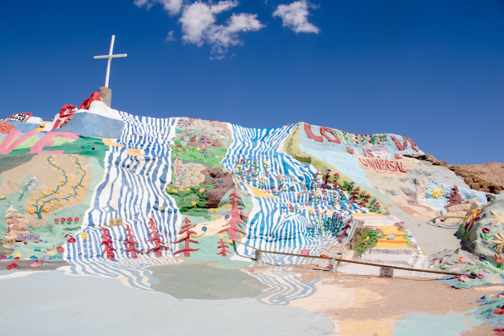 white and blue cross graffiti on wall