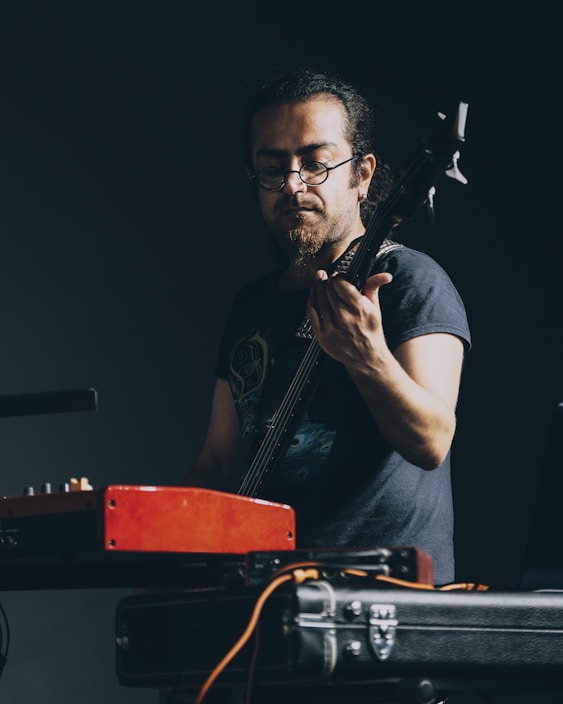 Musician plugging a custom cable into an electric guitar on stage