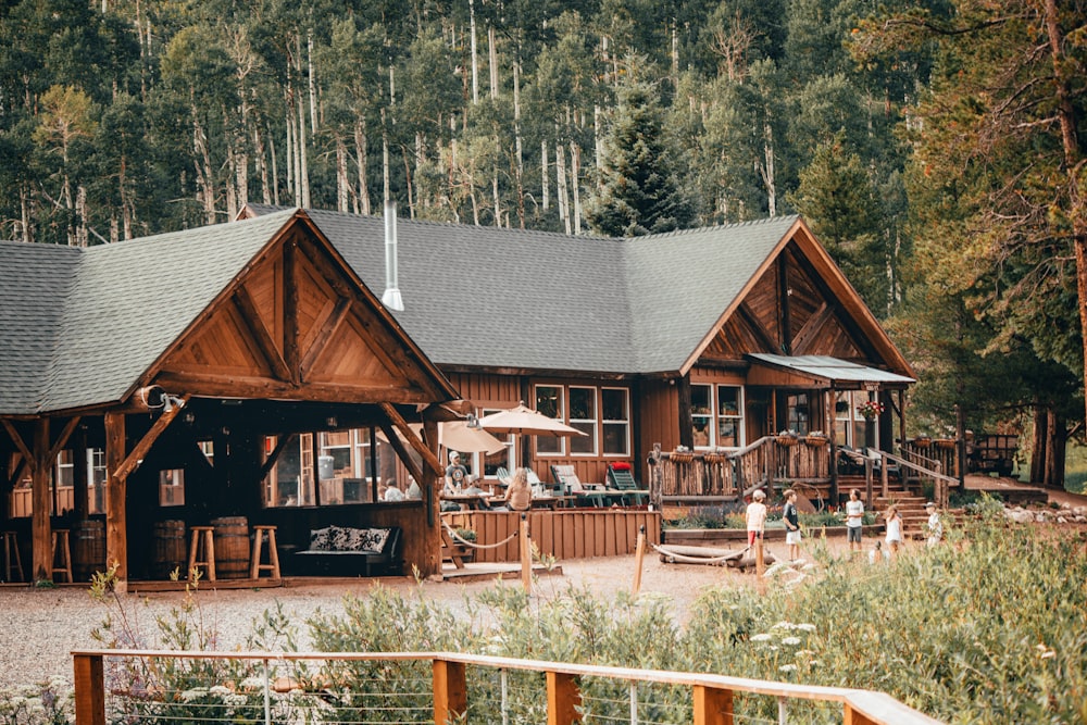 brown wooden house near green trees during daytime