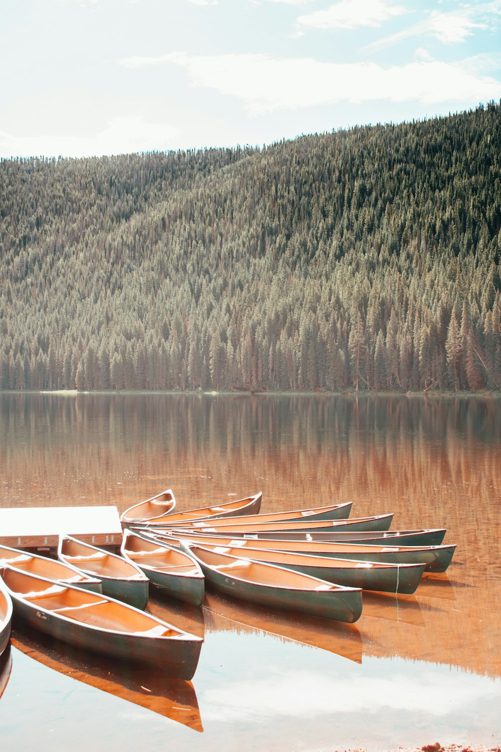 brown wooden boat on lake during daytime