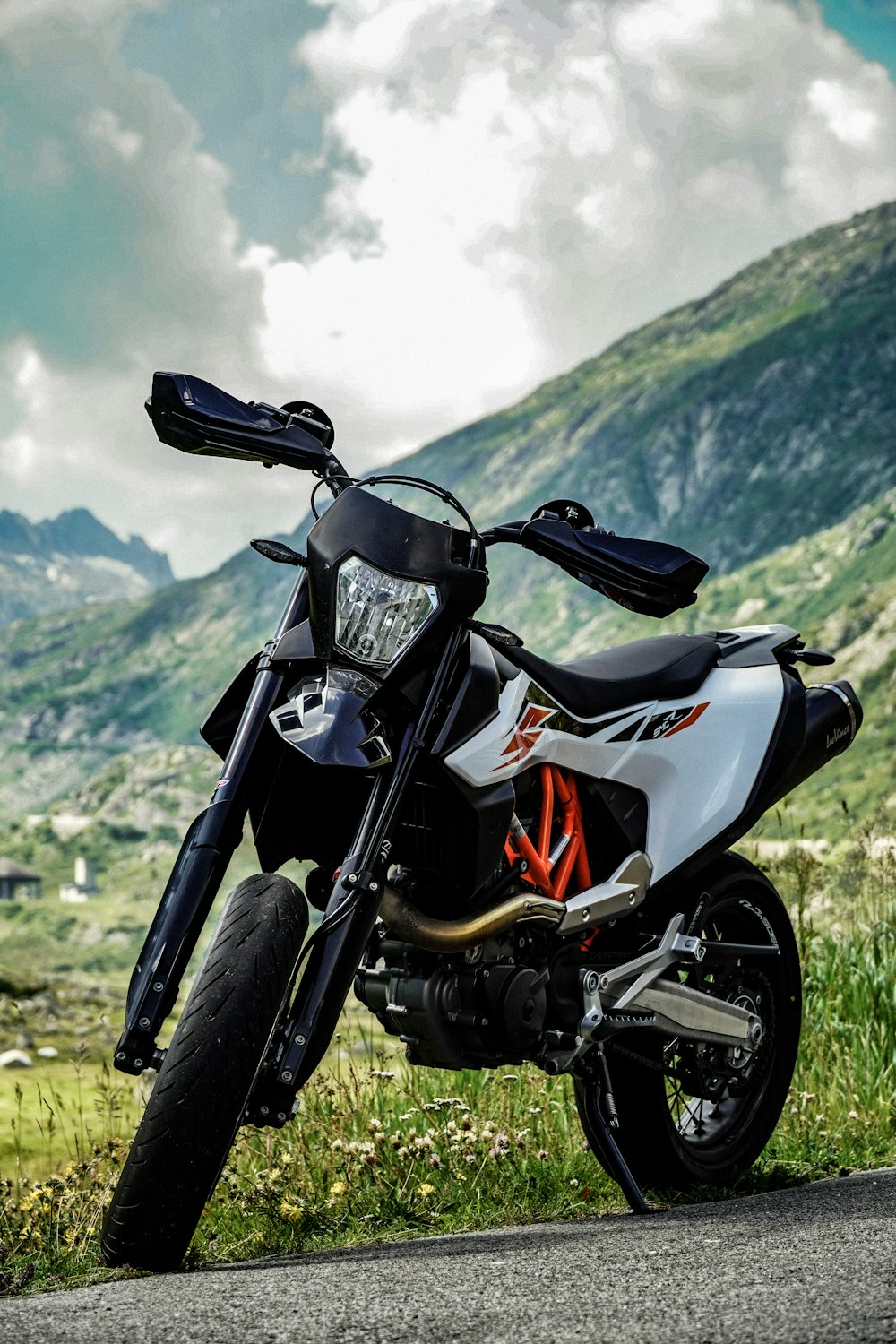 black and red sports bike on green grass field during daytime