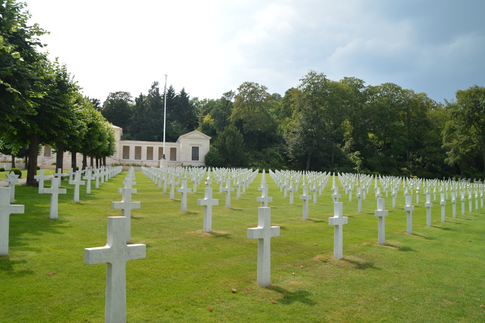 white cross on green grass field during daytime