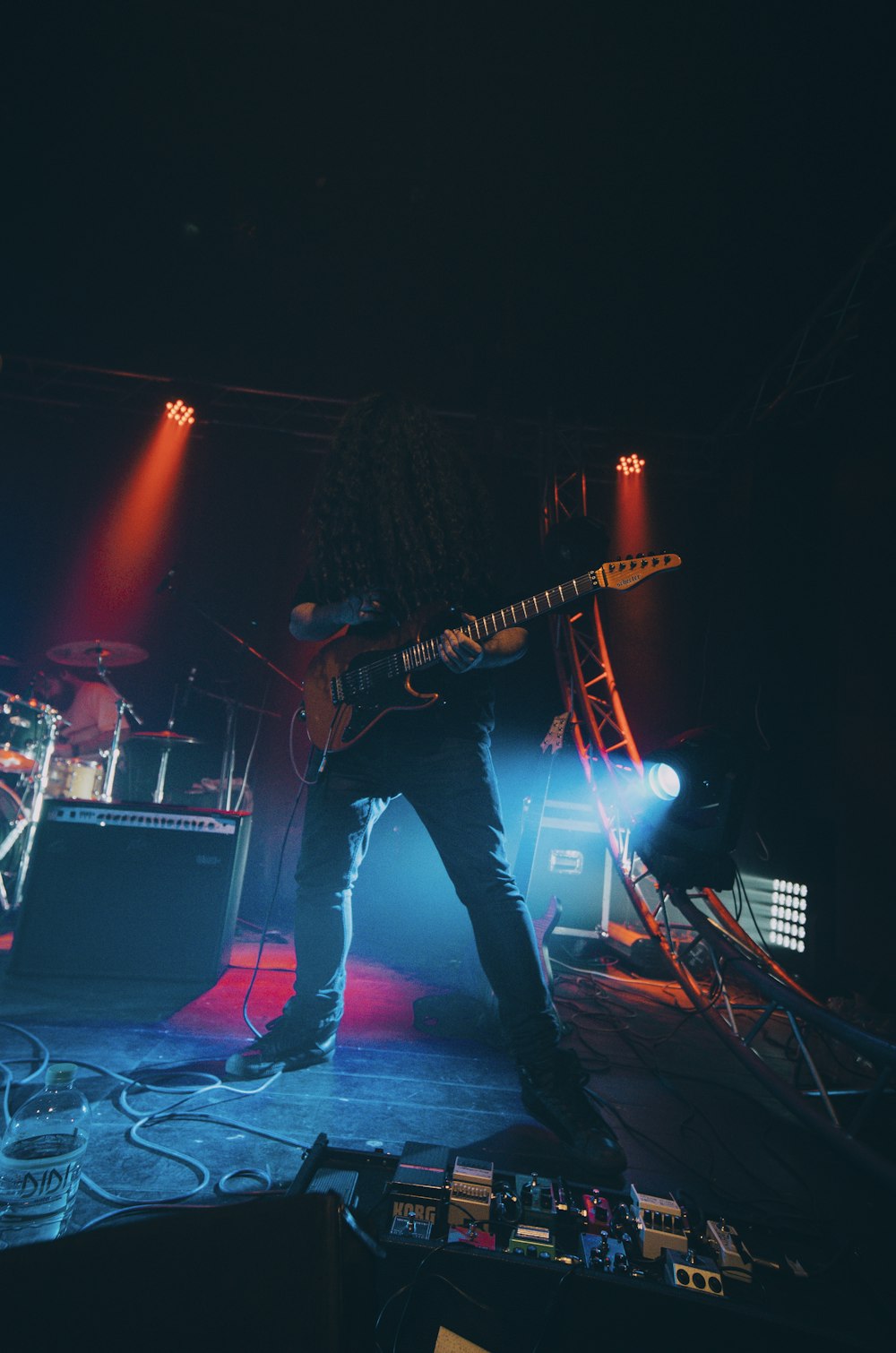 man playing electric guitar on stage