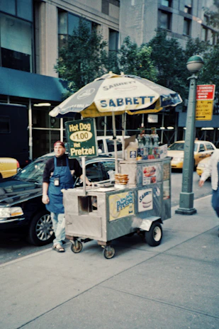 Close-up of a Sabrett hotdog steaming on a classic New York street cart.