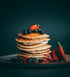 pancakes with strawberries and blueberries on top