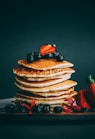 pancakes with strawberries and blueberries on top