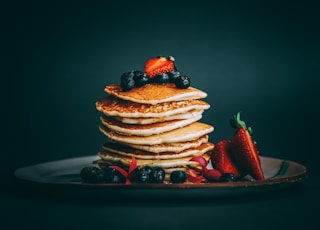 pancakes with strawberries and blueberries on top