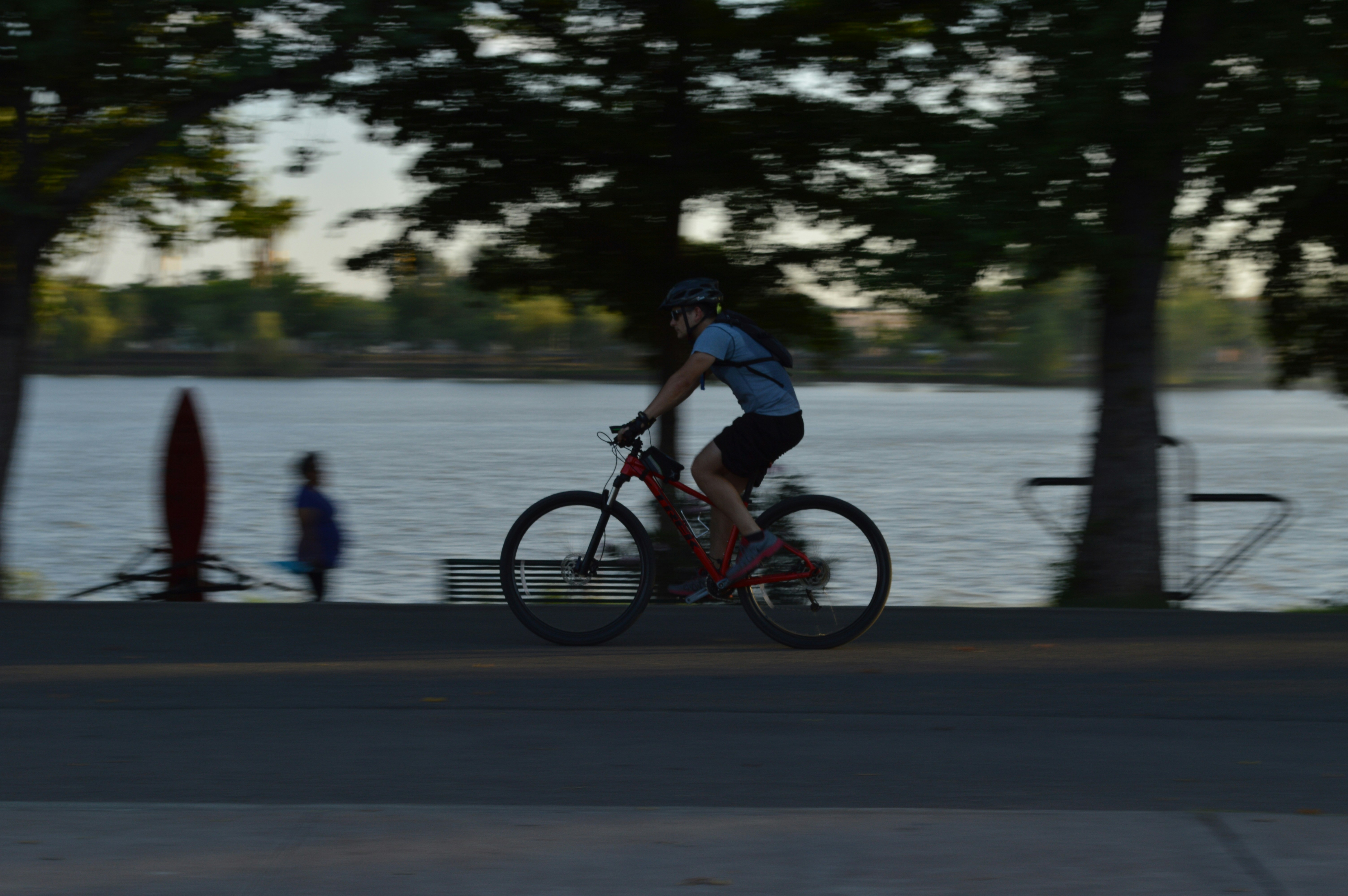 man in black shirt riding bicycle on road during daytime