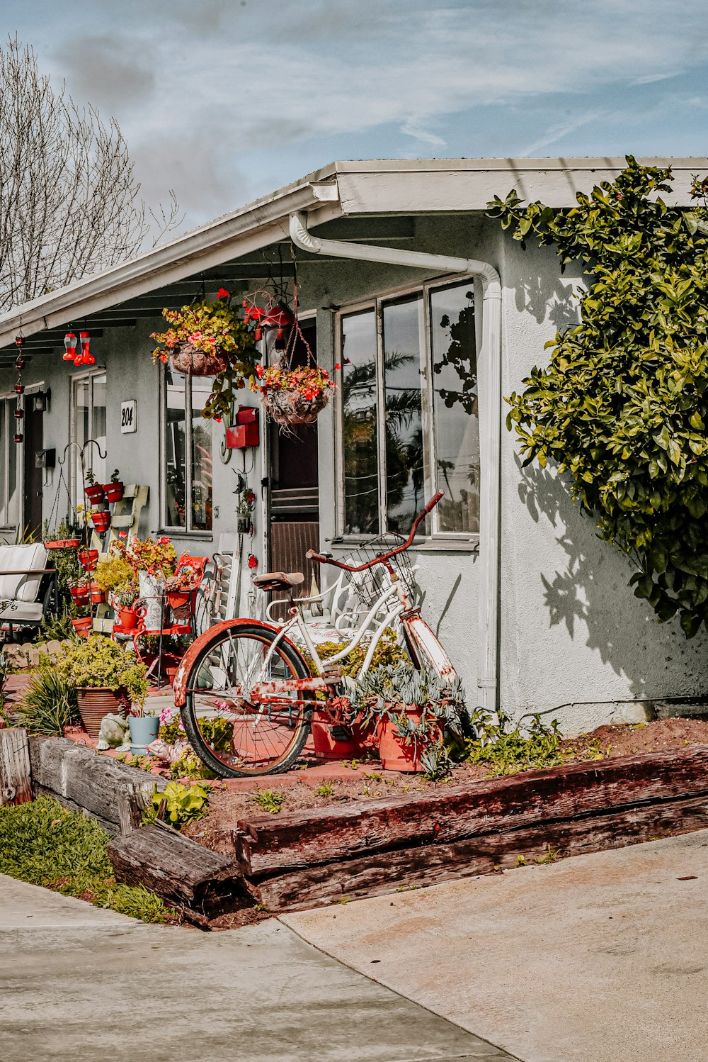 red bicycle parked beside white concrete building