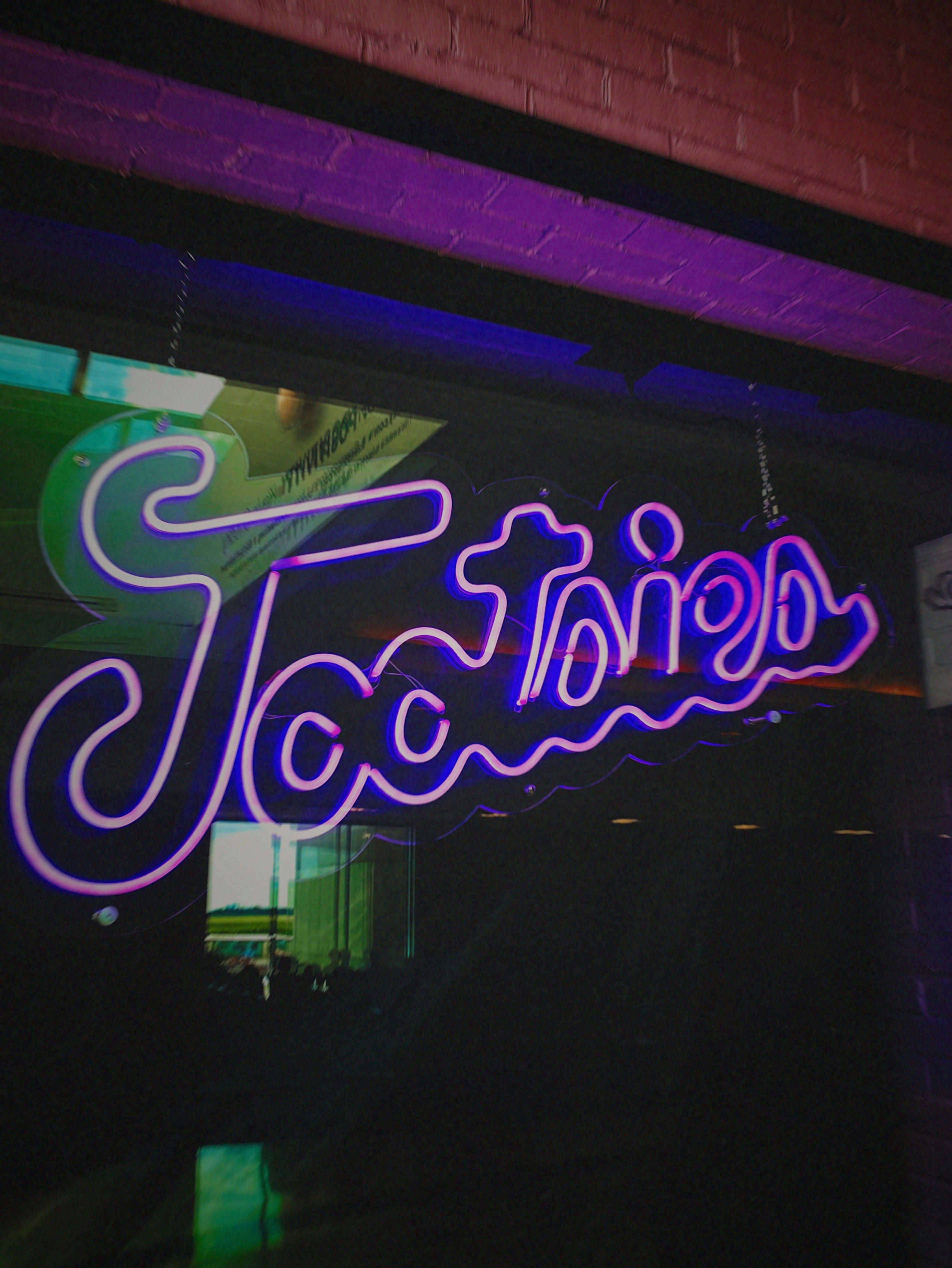 a neon sign on the side of a building