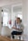 woman in white dress shirt sitting on chair