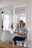 woman in white dress shirt sitting on chair