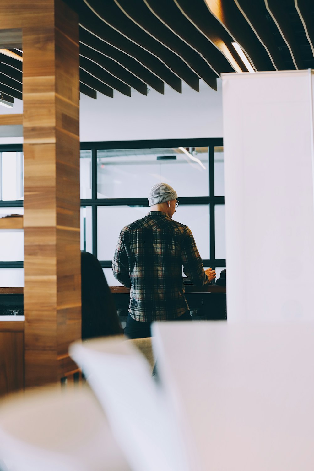 man in black and white plaid dress shirt sitting on chair