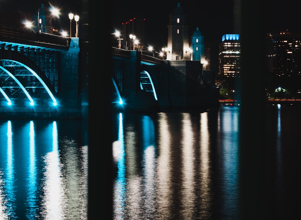 blue bridge over water during night time