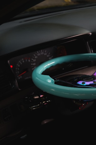 A close-up of a sleek car dashboard illuminated under soft lighting.