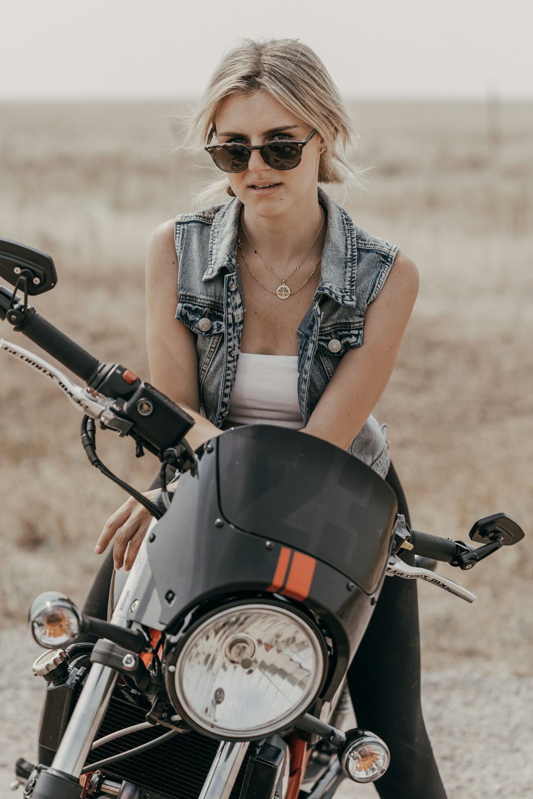 woman in grey tank top riding motorcycle