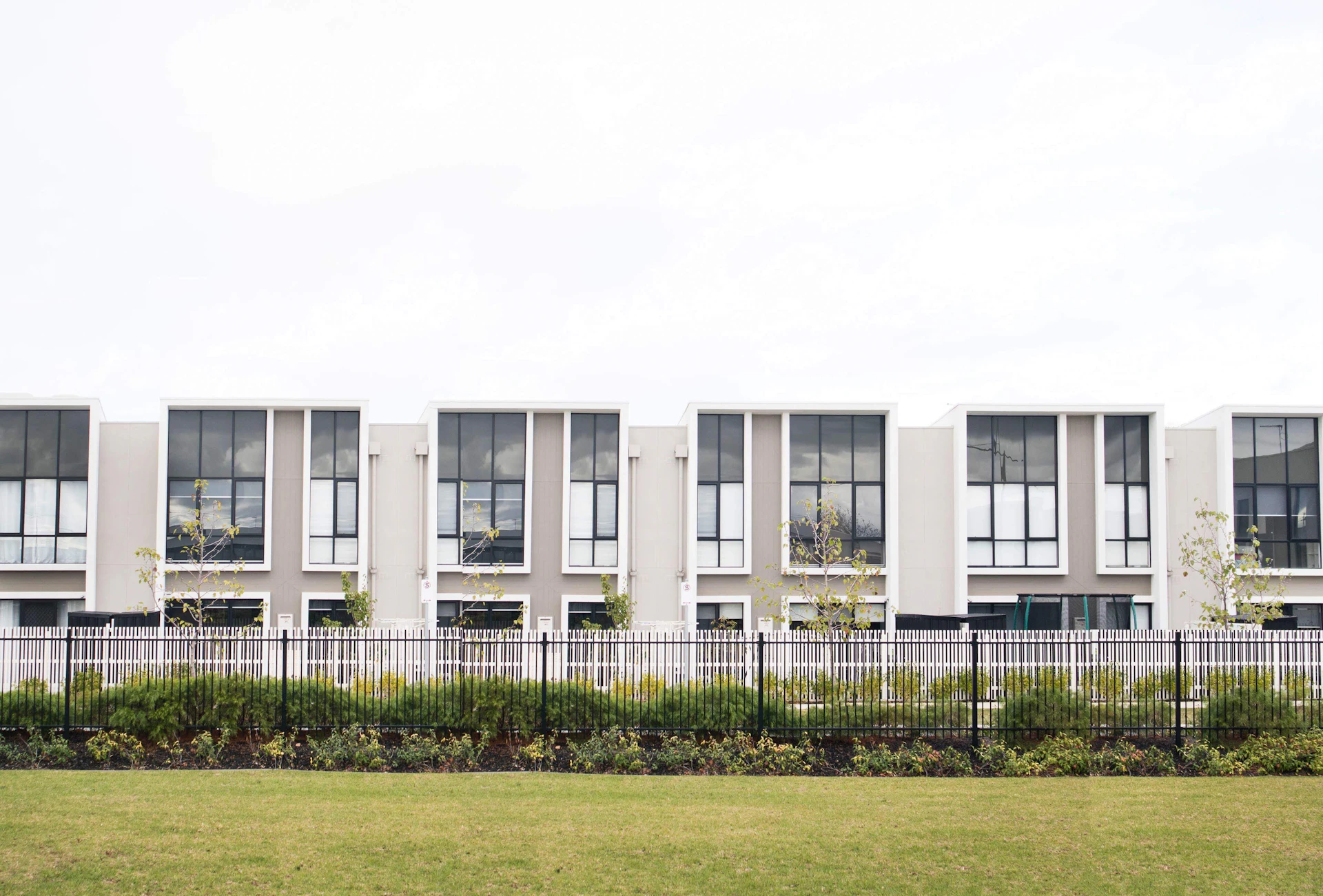 Modern white townhouse facade in daylight