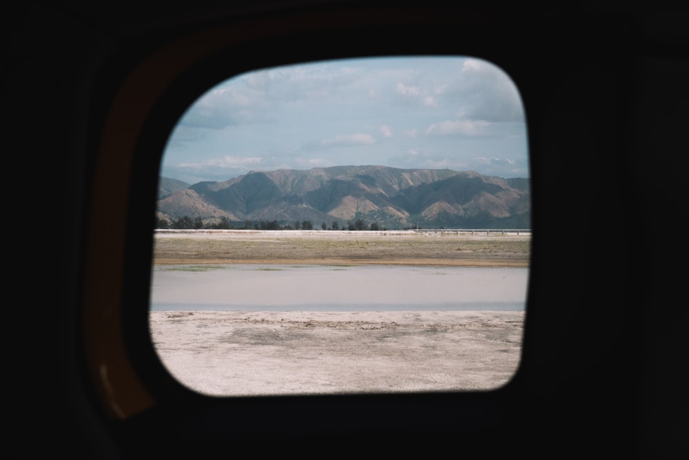 black car side mirror near body of water during daytime