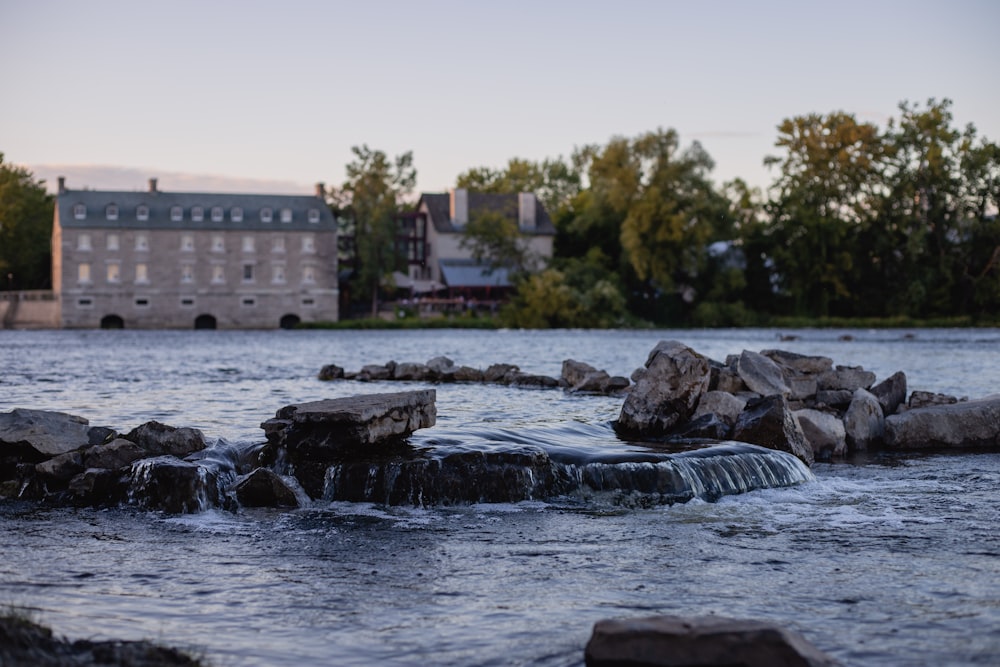 water falls near brown concrete building during daytime