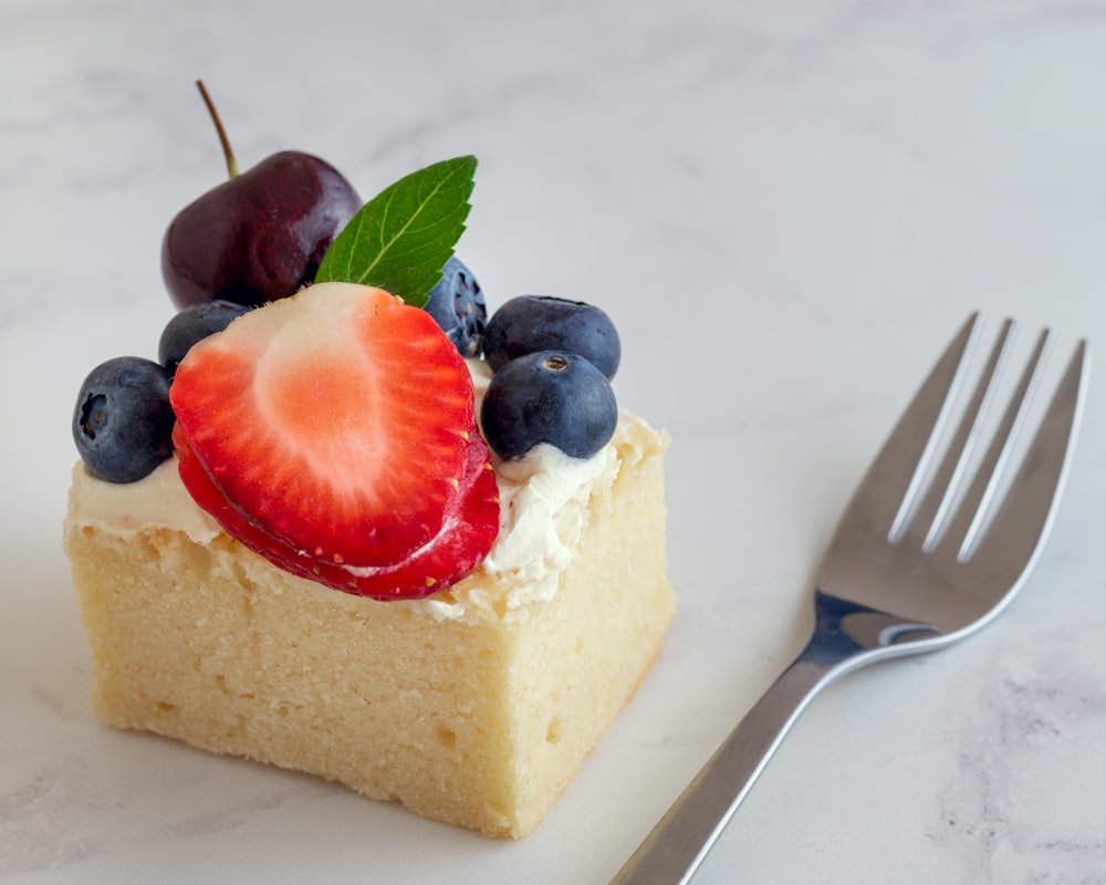 sliced cake with strawberry on top