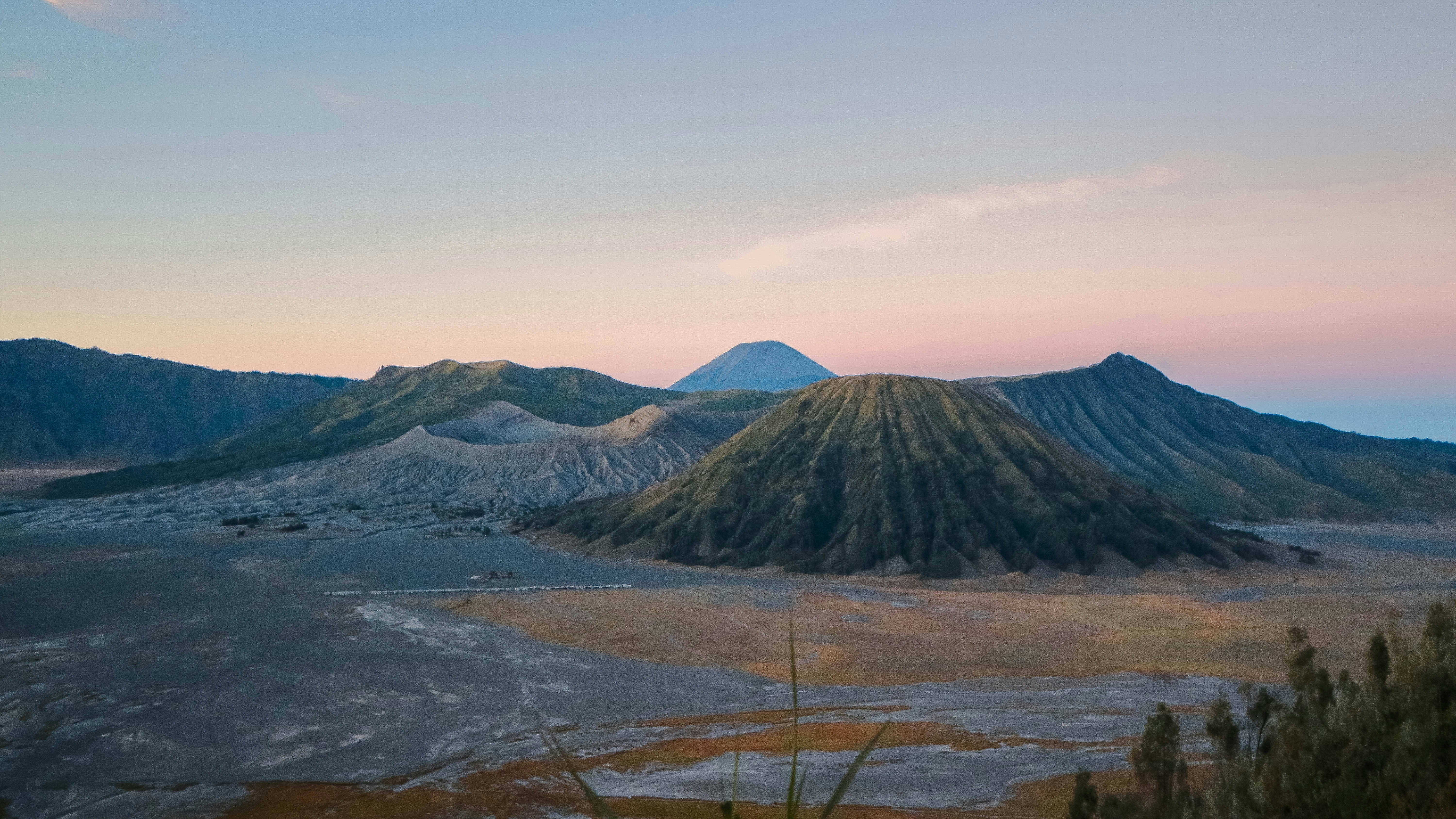 green and brown mountains under white sky during daytime