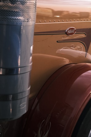 Close-up of a truck's dented aluminum side before repair and the smooth, polished finish after ATS Truck and Trailer Repair's work.