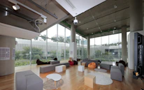 Bright and spacious student lounge filled with natural light and cozy seating areas.