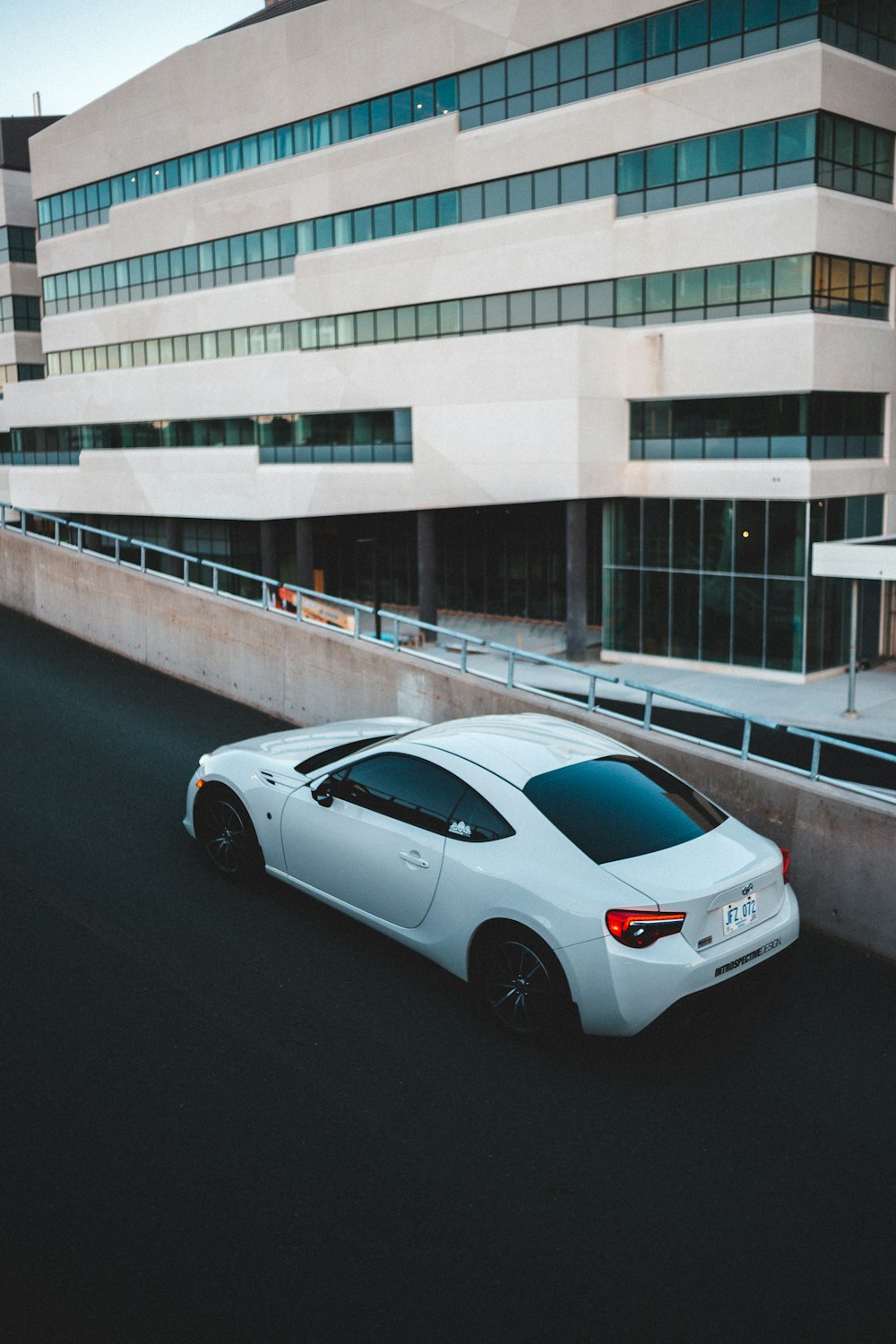 white coupe on road during daytime