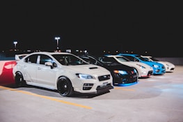 white bmw coupe on parking lot during night time
