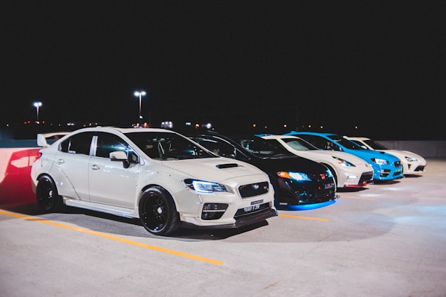 white bmw coupe on parking lot during night time