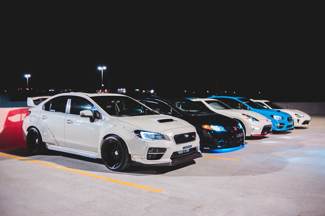 white bmw coupe on parking lot during night time