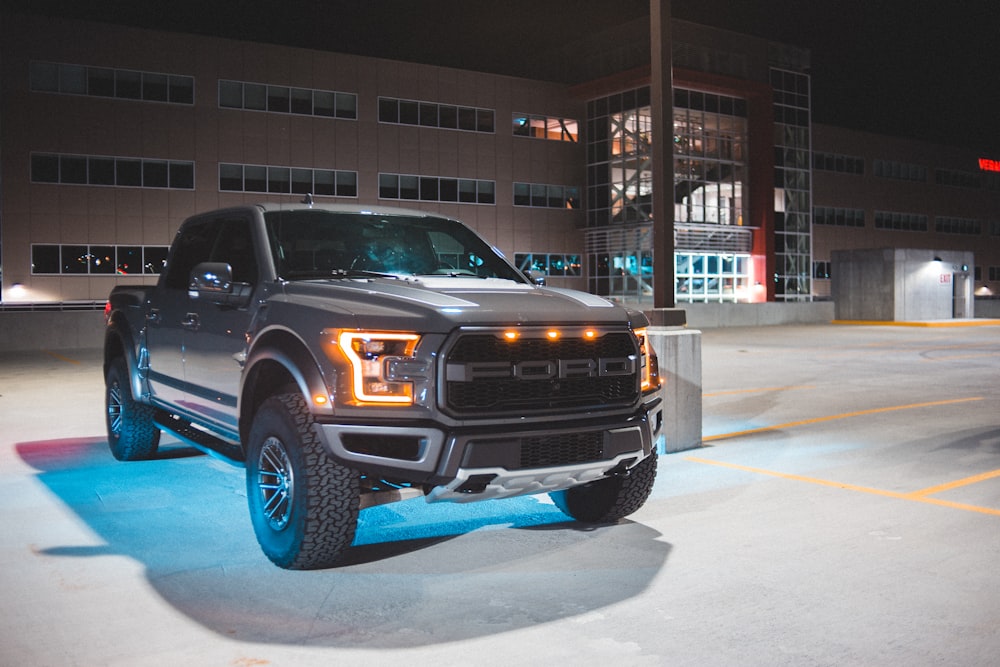 black chevrolet crew cab pickup truck parked on road side during daytime