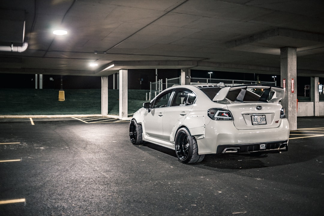 white coupe parked on parking lot