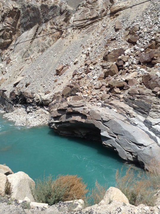 rocky river between rocky mountains during daytime in Ladakh India