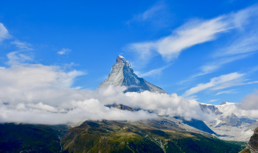 green and white mountain under blue sky and white clouds during daytime