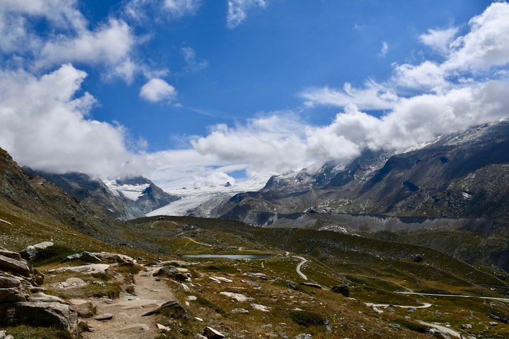 green and brown mountains under blue sky and white clouds during daytime