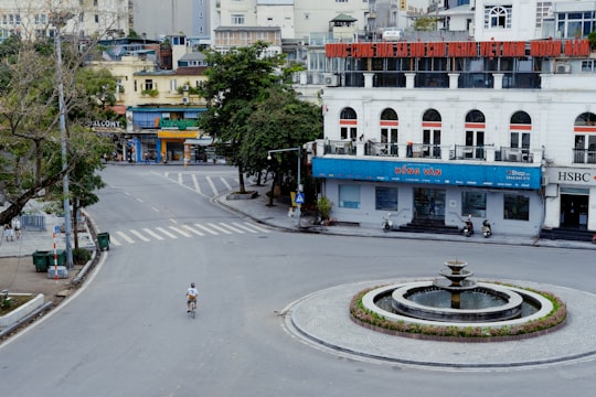 people walking on sidewalk near building during daytime in Highlands Coffee Vietnam