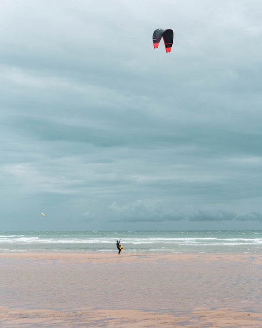 person in black shirt walking on beach during daytime in Escalles France