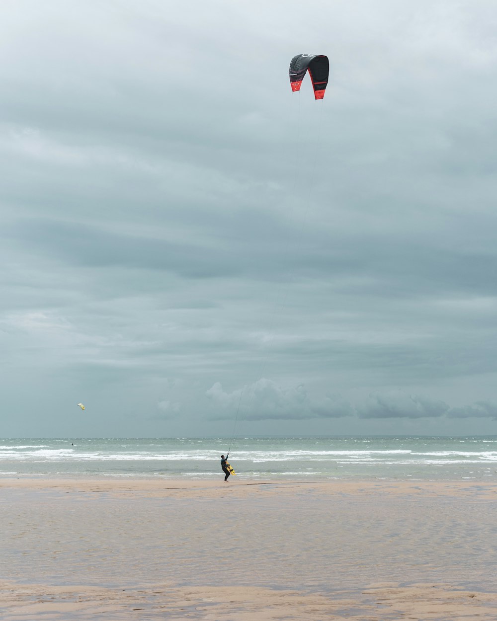 person in black shirt walking on beach during daytime