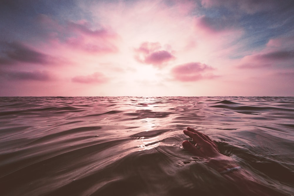 body of water under cloudy sky during daytime