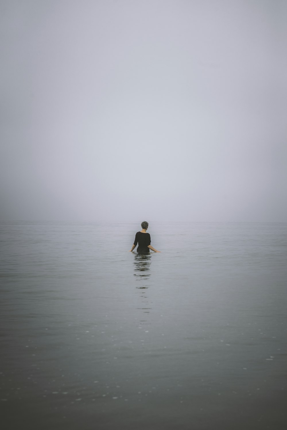 woman in black and red dress on water during daytime