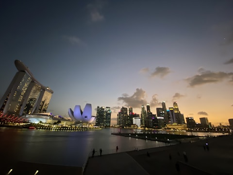 A vibrant city skyline at dusk showcasing modern hotel developments.