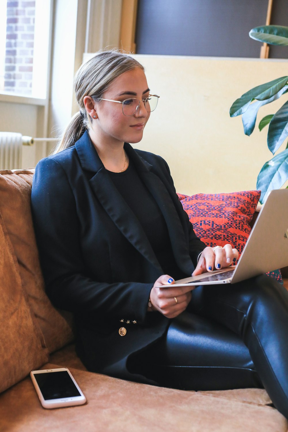 Femme en blazer noir utilisant un MacBook